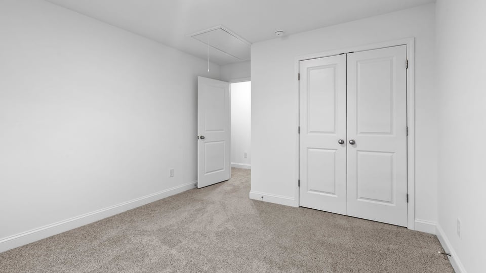 Bedroom with window and carpet.