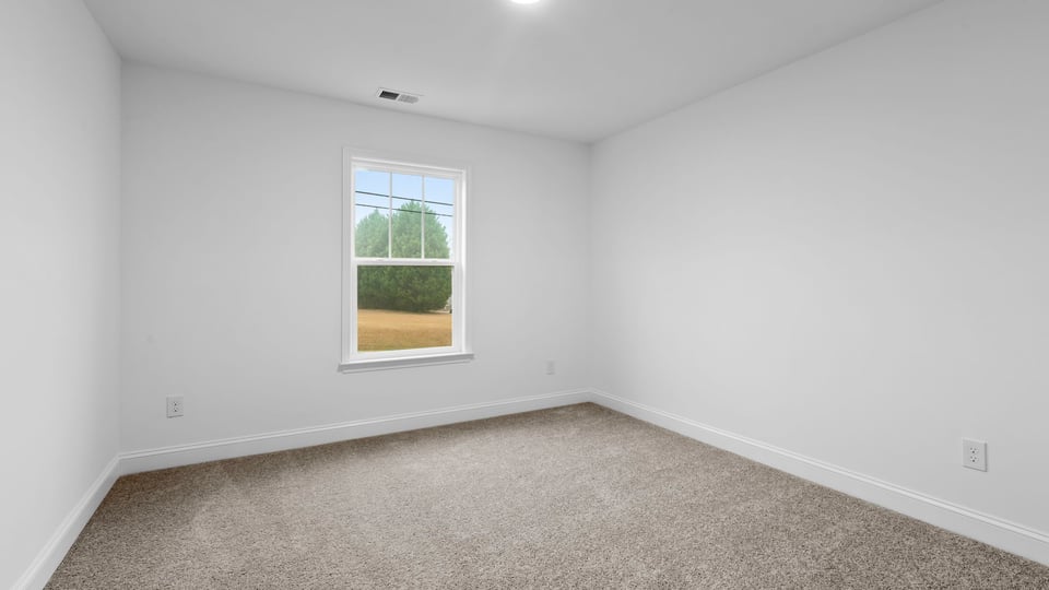 Bedroom with window and carpet.