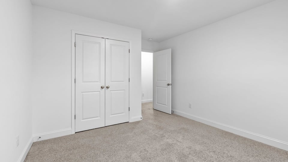 Bedroom with window and carpet.
