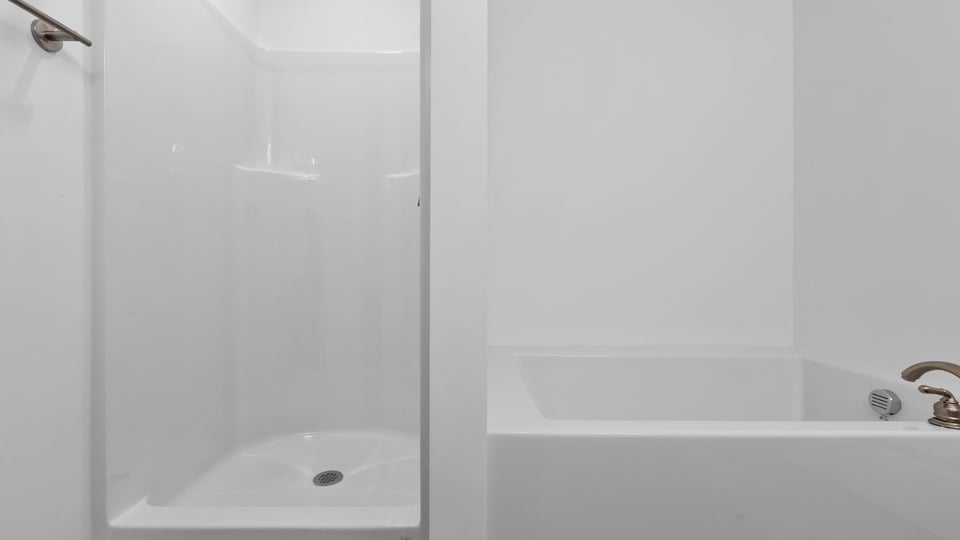 Primary bathroom with garden tub and walk-in shower.