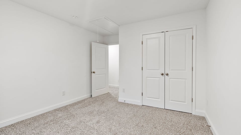 Bedroom with window and carpet.