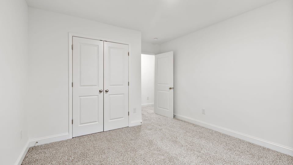 Bedroom with window and carpet.