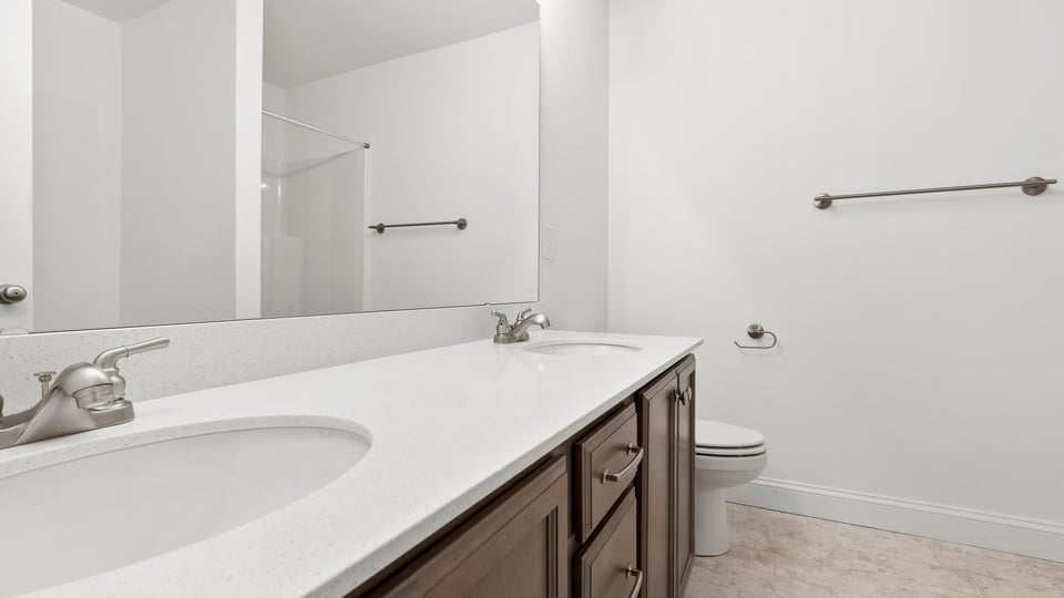 Primary bedroom with large window and carpet.