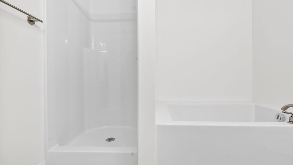 Primary bathroom with garden tub and walk-in shower.