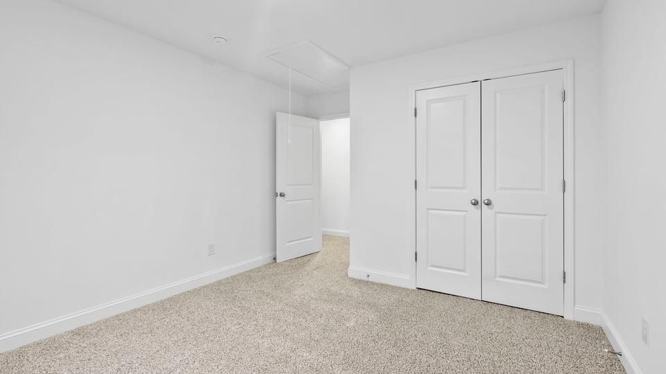Bedroom with window and carpet.