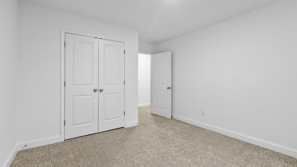 Bedroom with window and carpet.