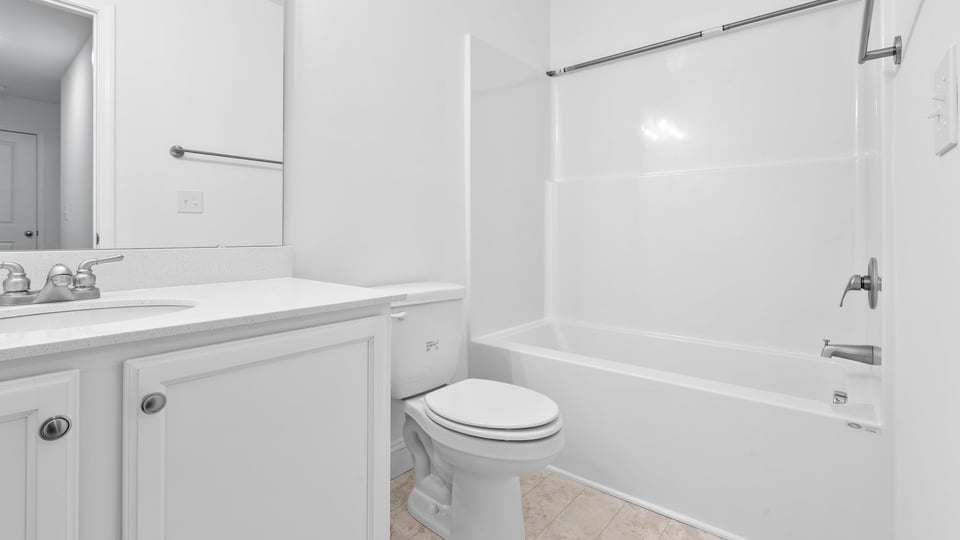 Hall bathroom with vanity and combination shower / tub.