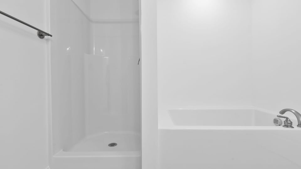 Primary bathroom with garden tub and walk-in shower.