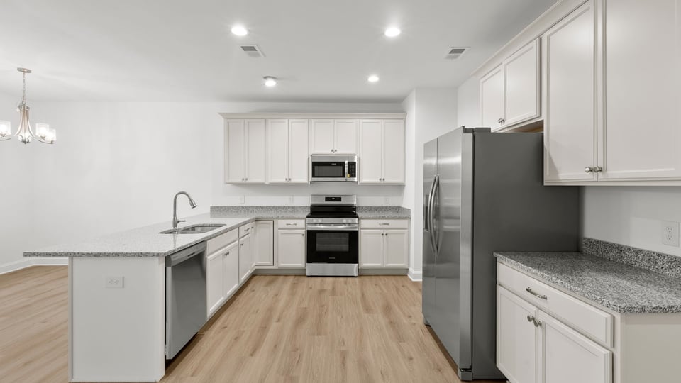 Kitchen with cabinets and windows.