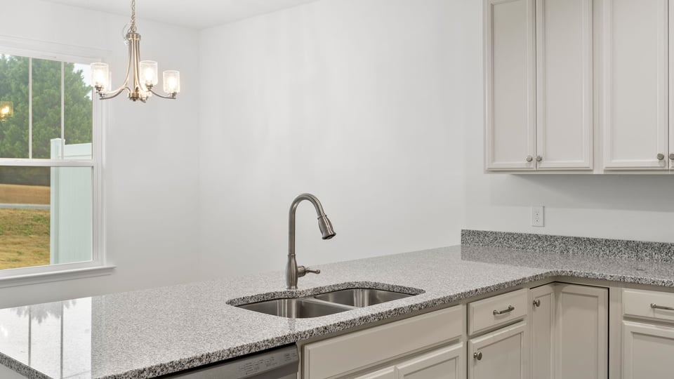 Kitchen with cabinets and windows.