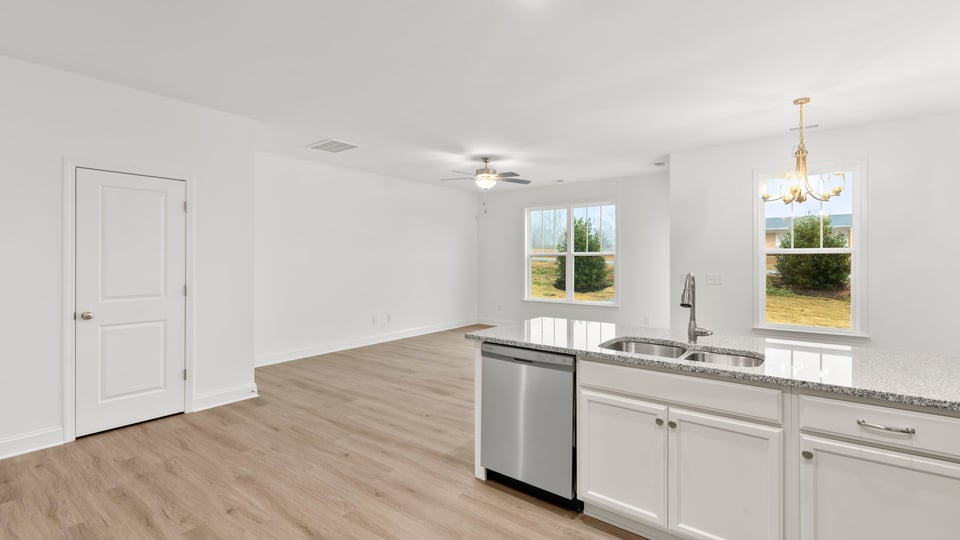 Kitchen with cabinets and windows.