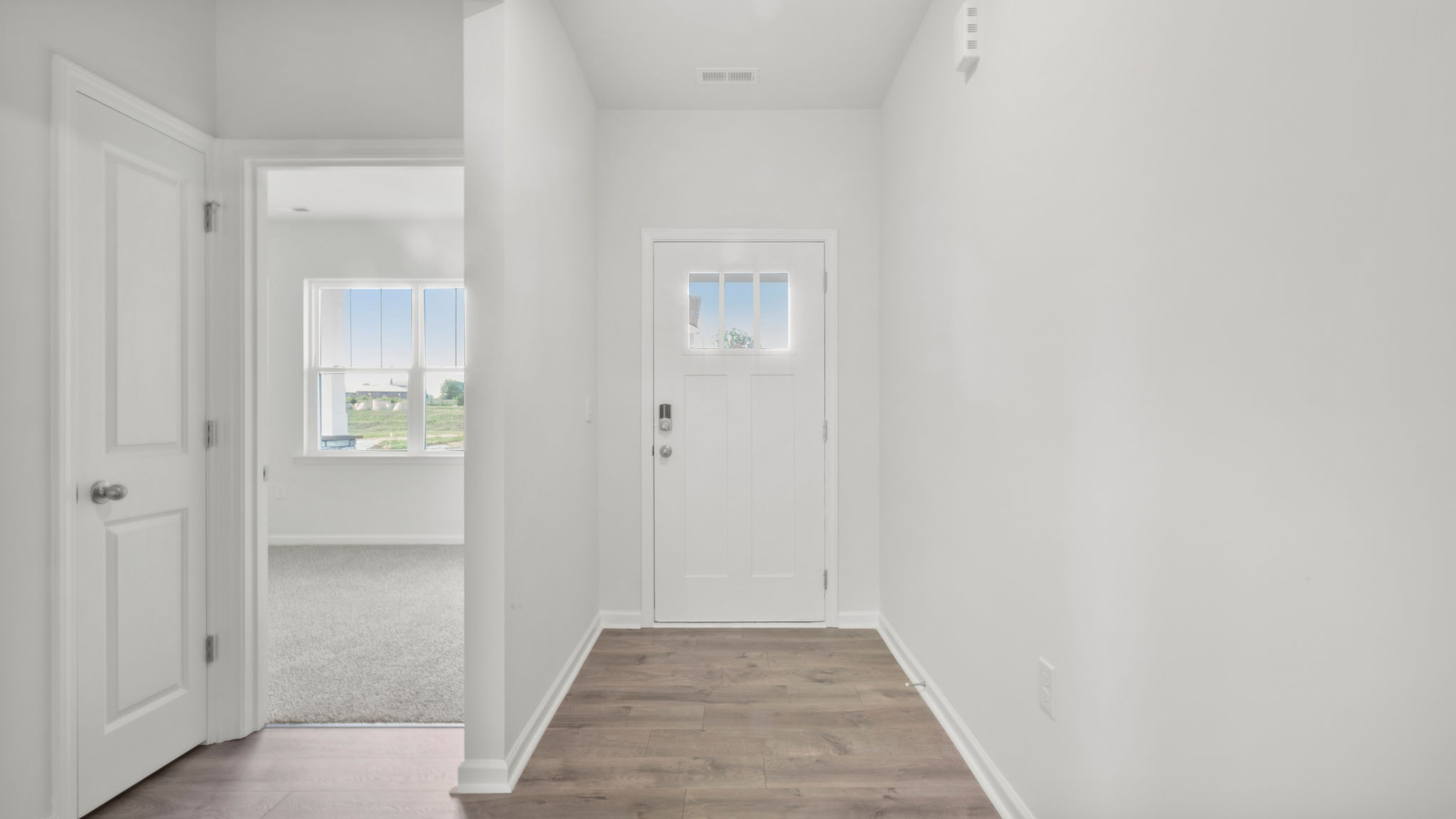 View of hallway and entrances to both bedrooms and hall bathroom.