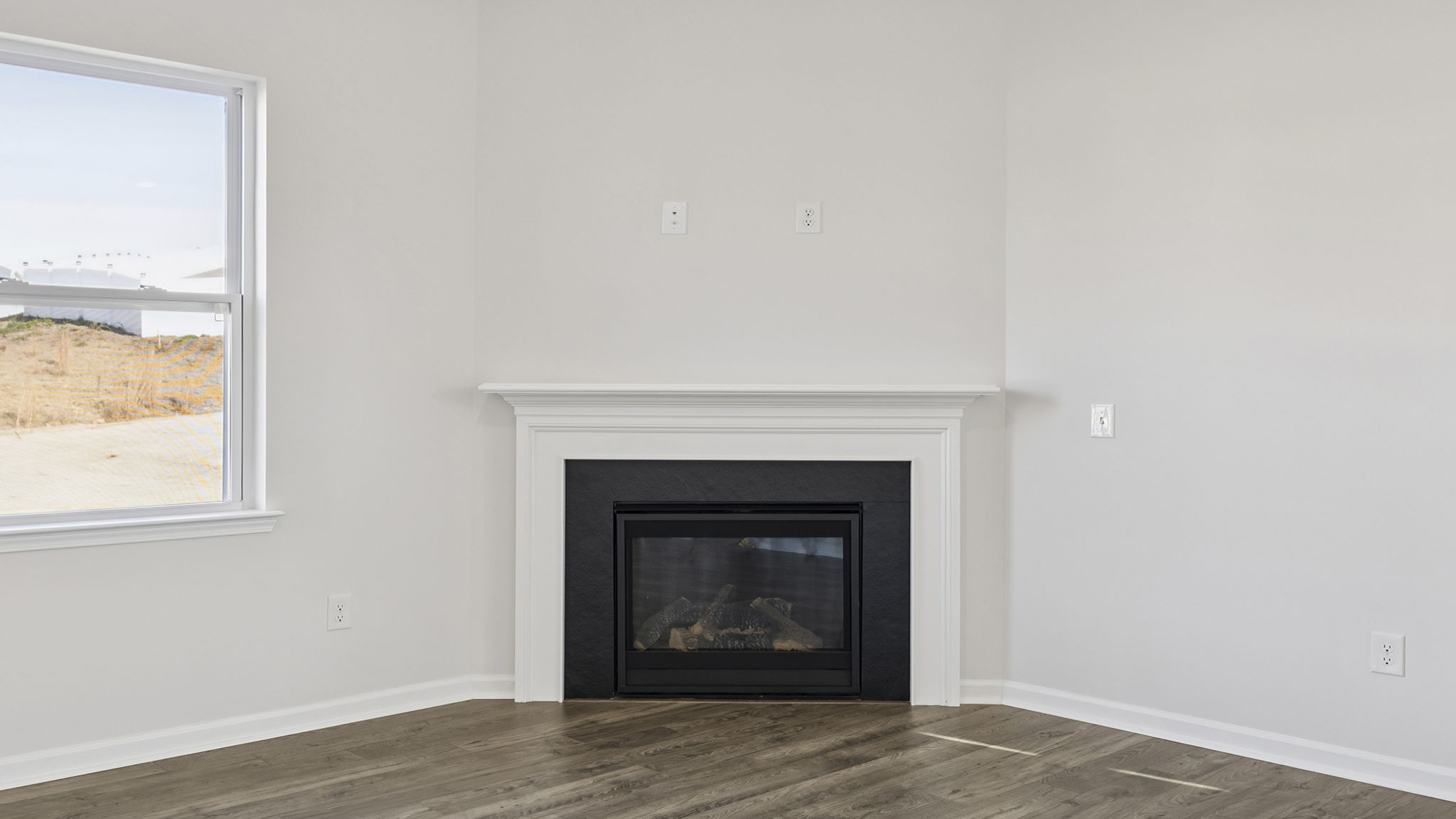 Family room with gas log fireplace and window.