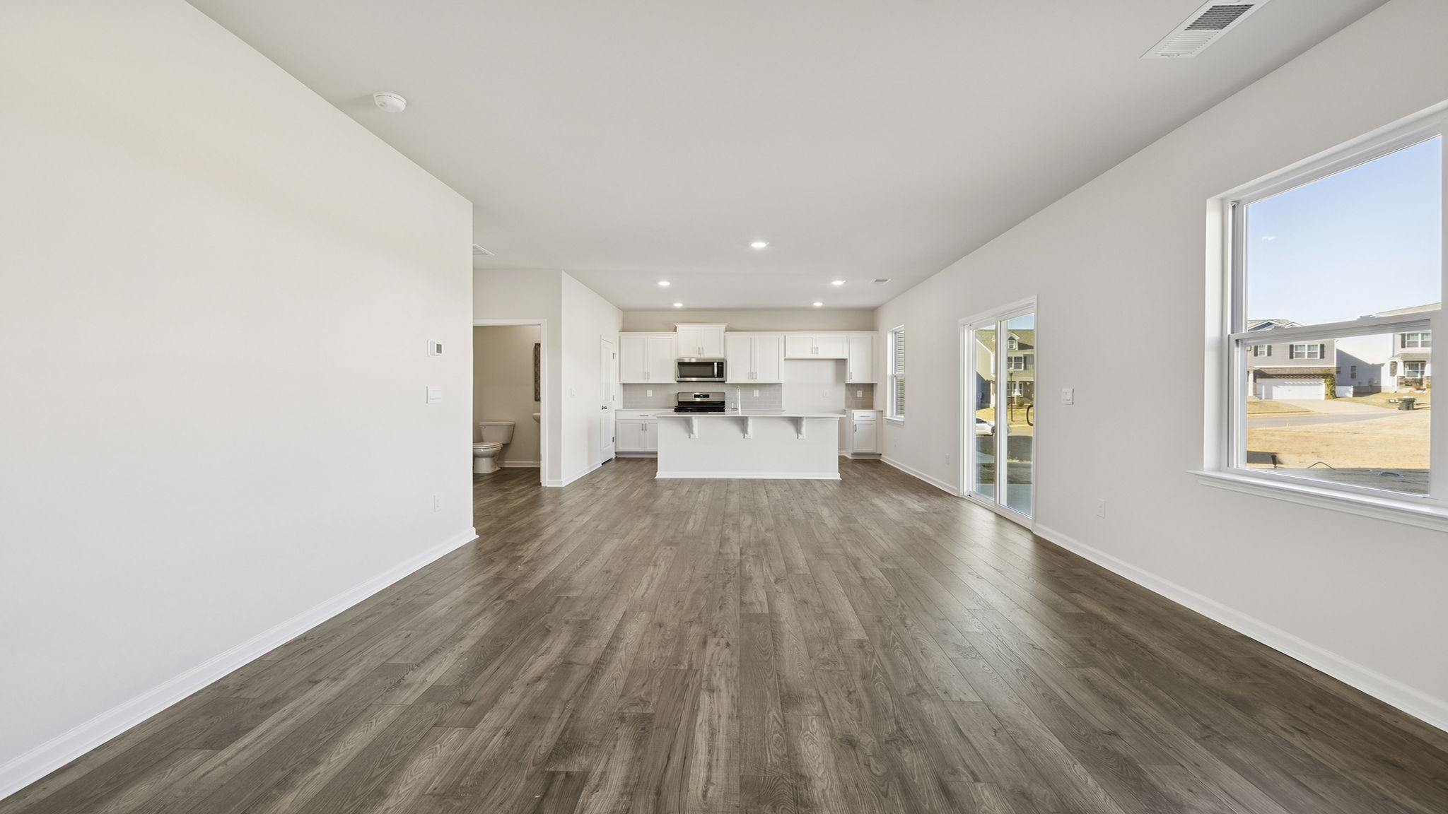 View of combination living and dining area open to the kitchen.