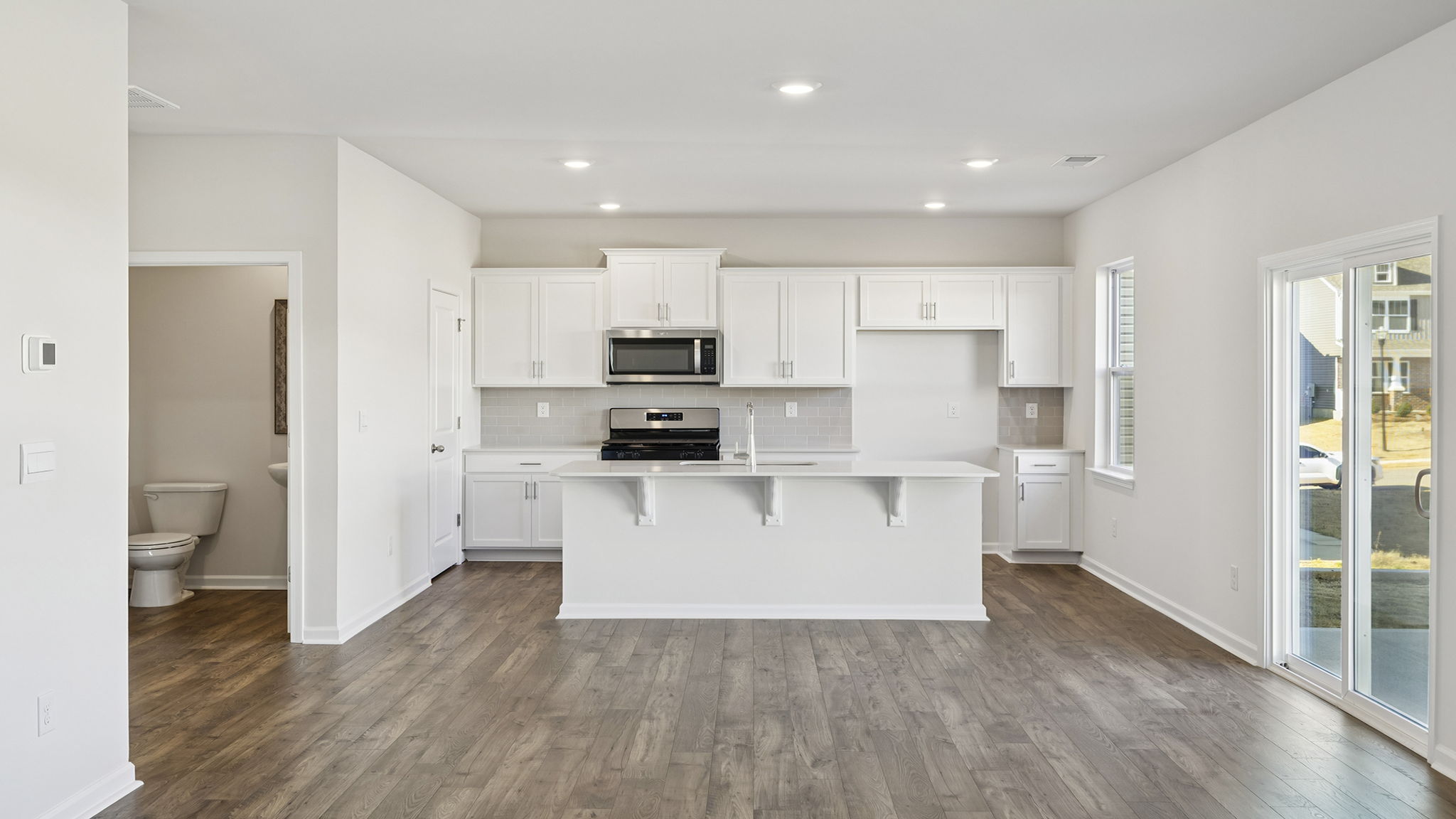 Kitchen and island with quartz counter tops.