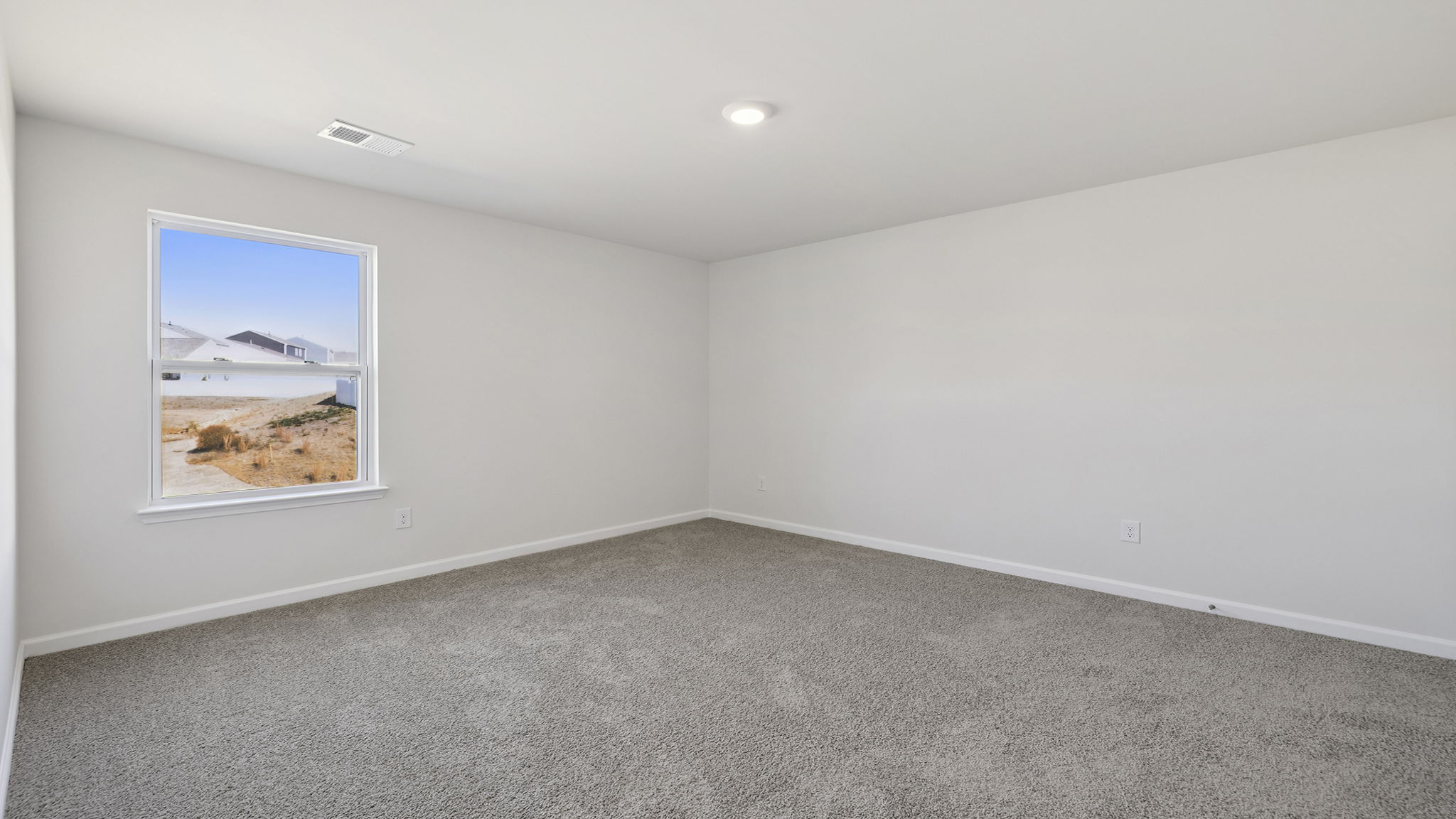 Bedroom with carpet and window.