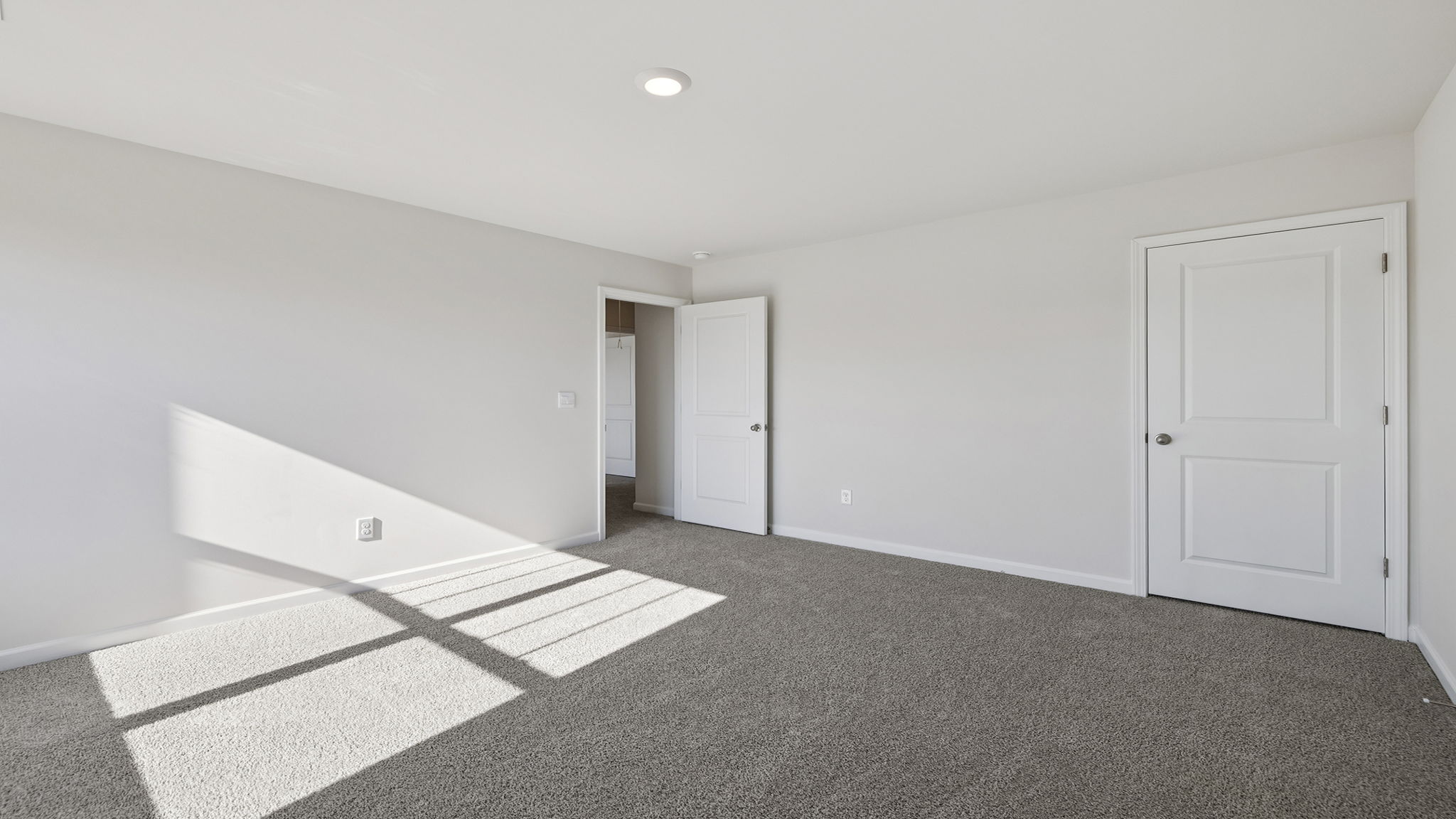 Bedroom with carpet and double window.