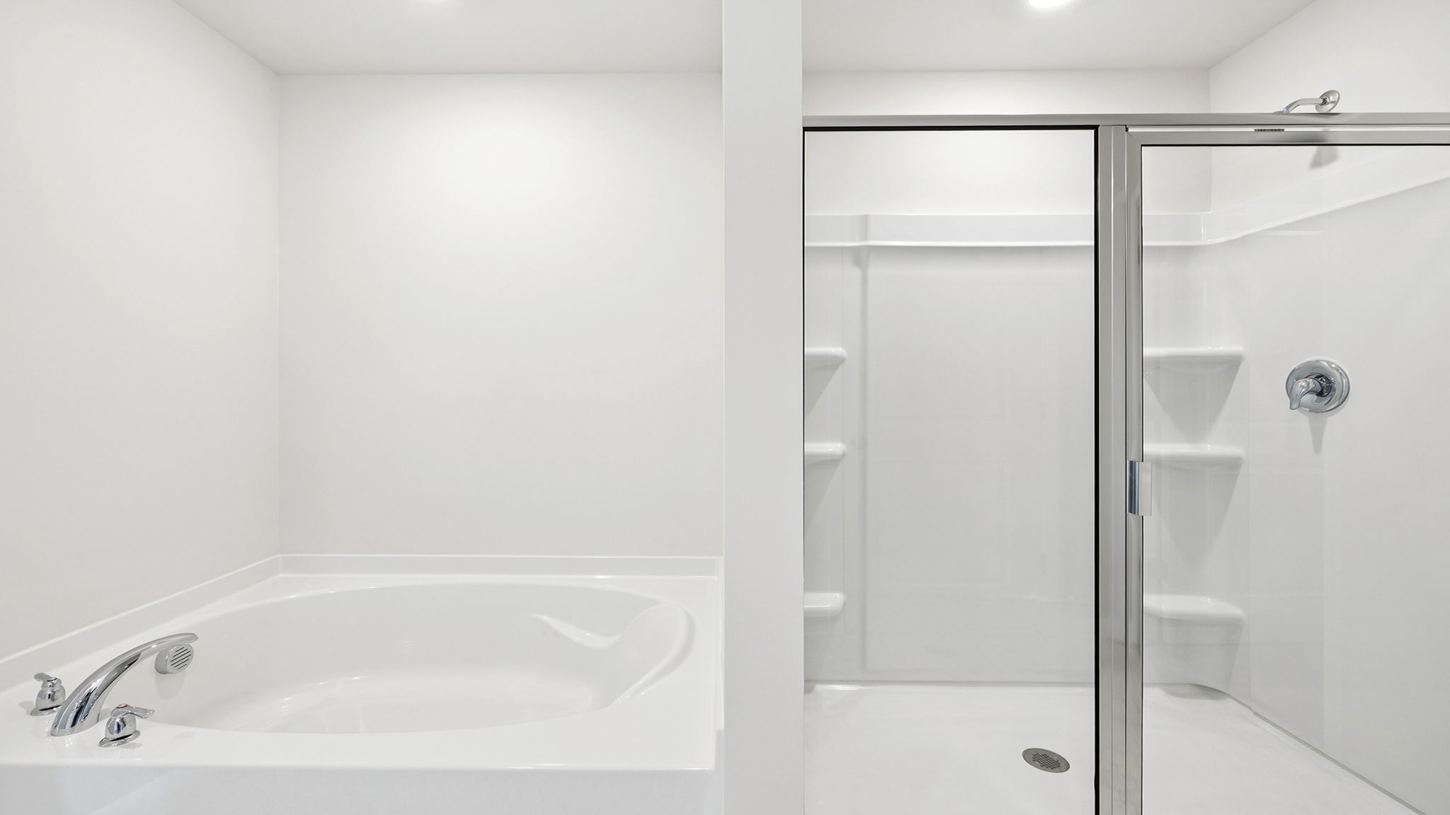Primary bathroom with walk-in shower and garden tub.