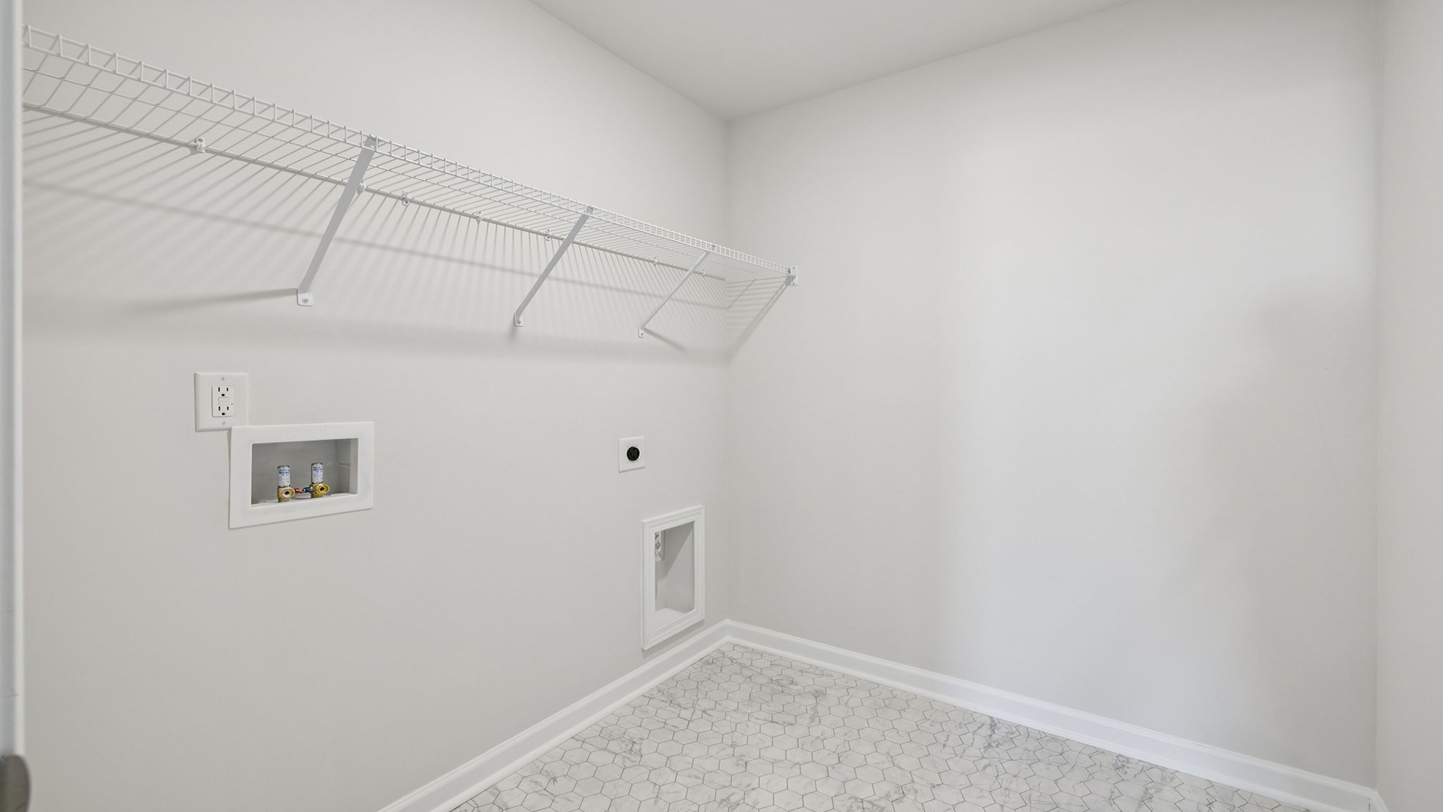 Walk-in laundry room with shelving.
