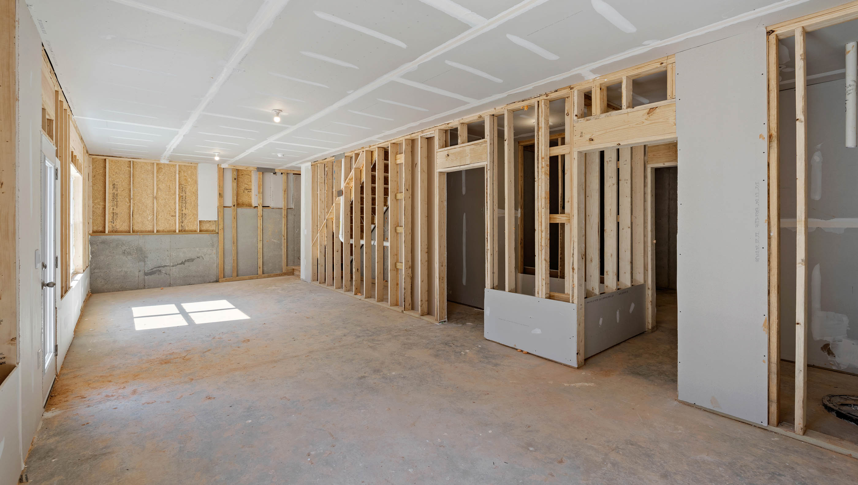 Unfinished basement with windows.