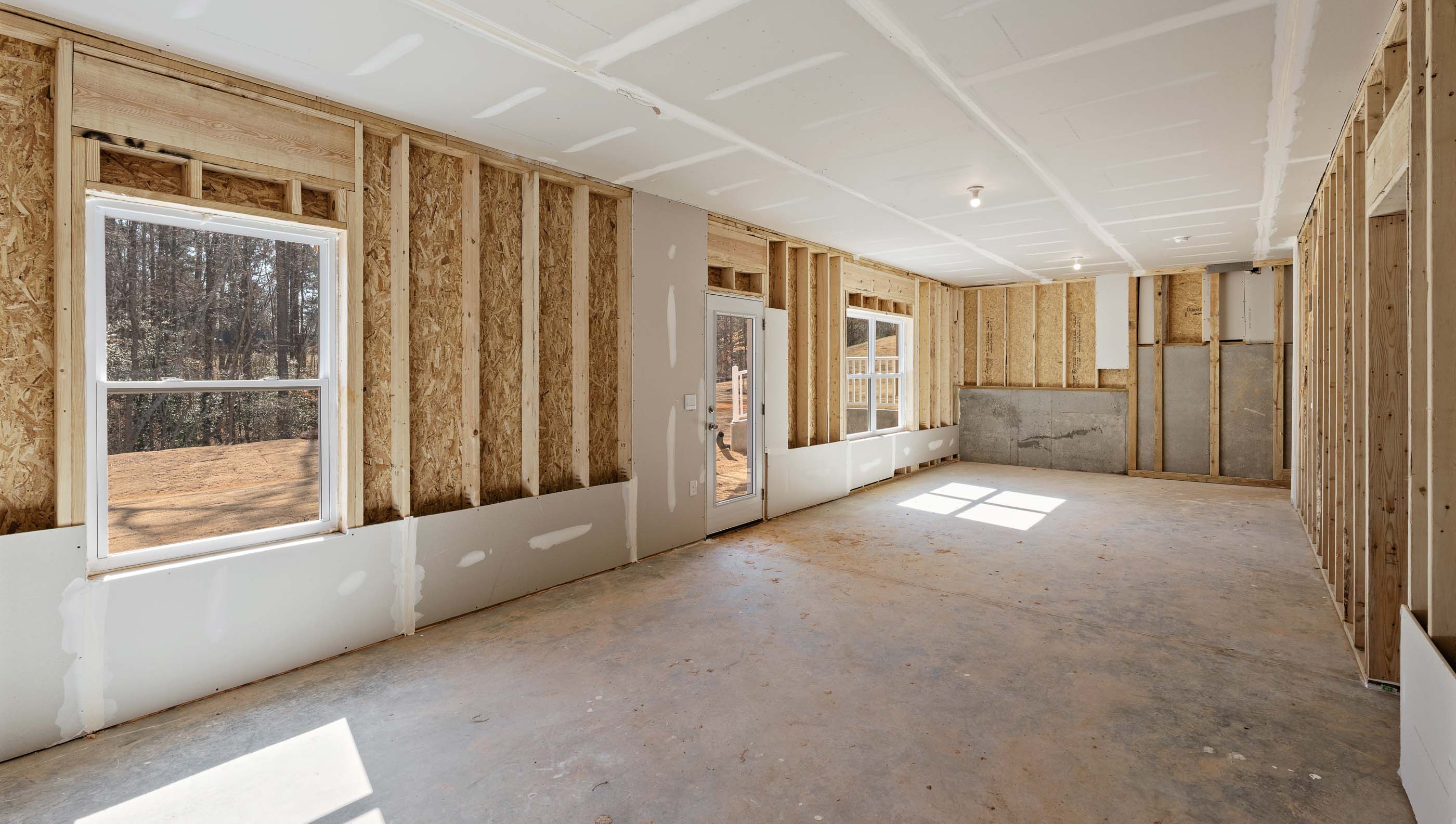 Unfinished basement with windows.