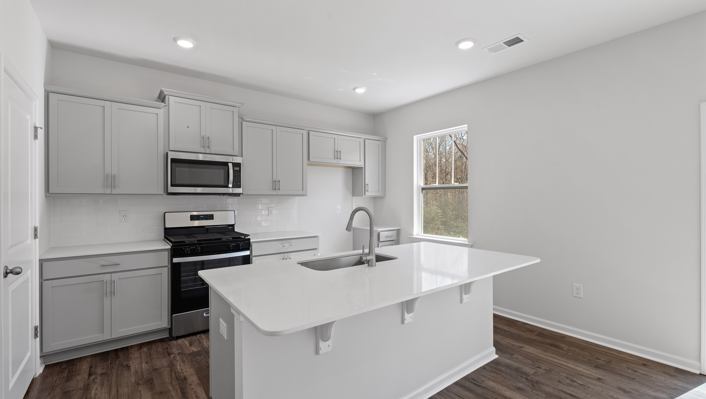 Kitchen with island and cabinets.