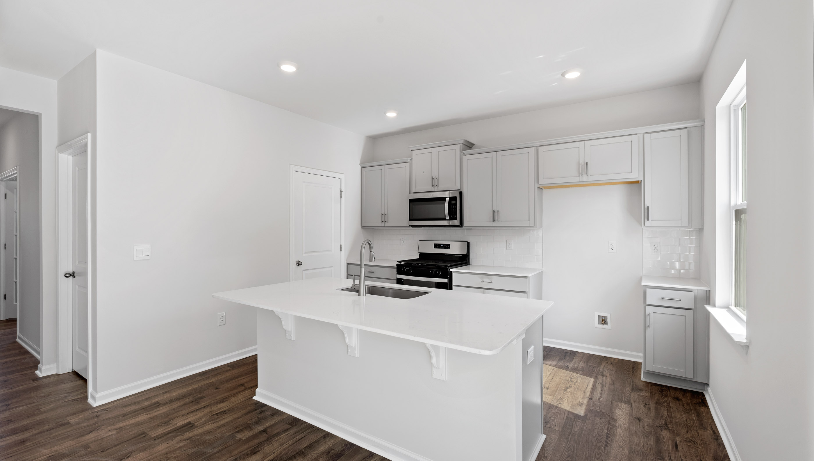 Kitchen with island and cabinets.