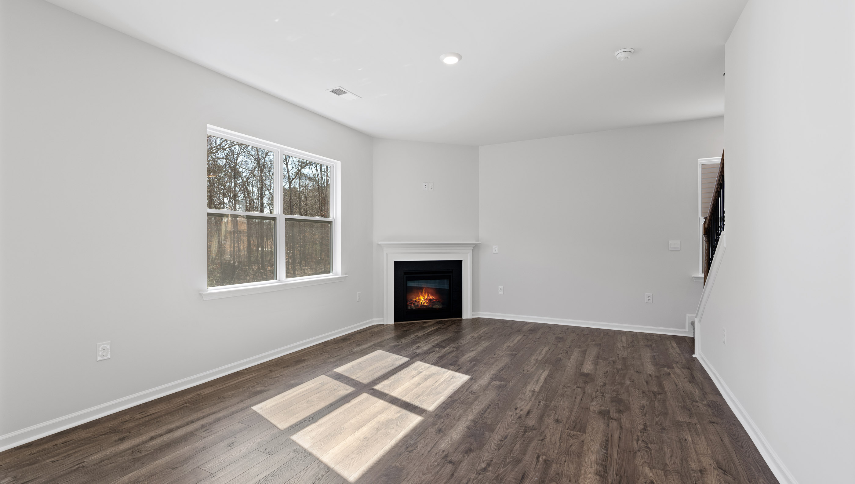 Living area with fireplace and windows.