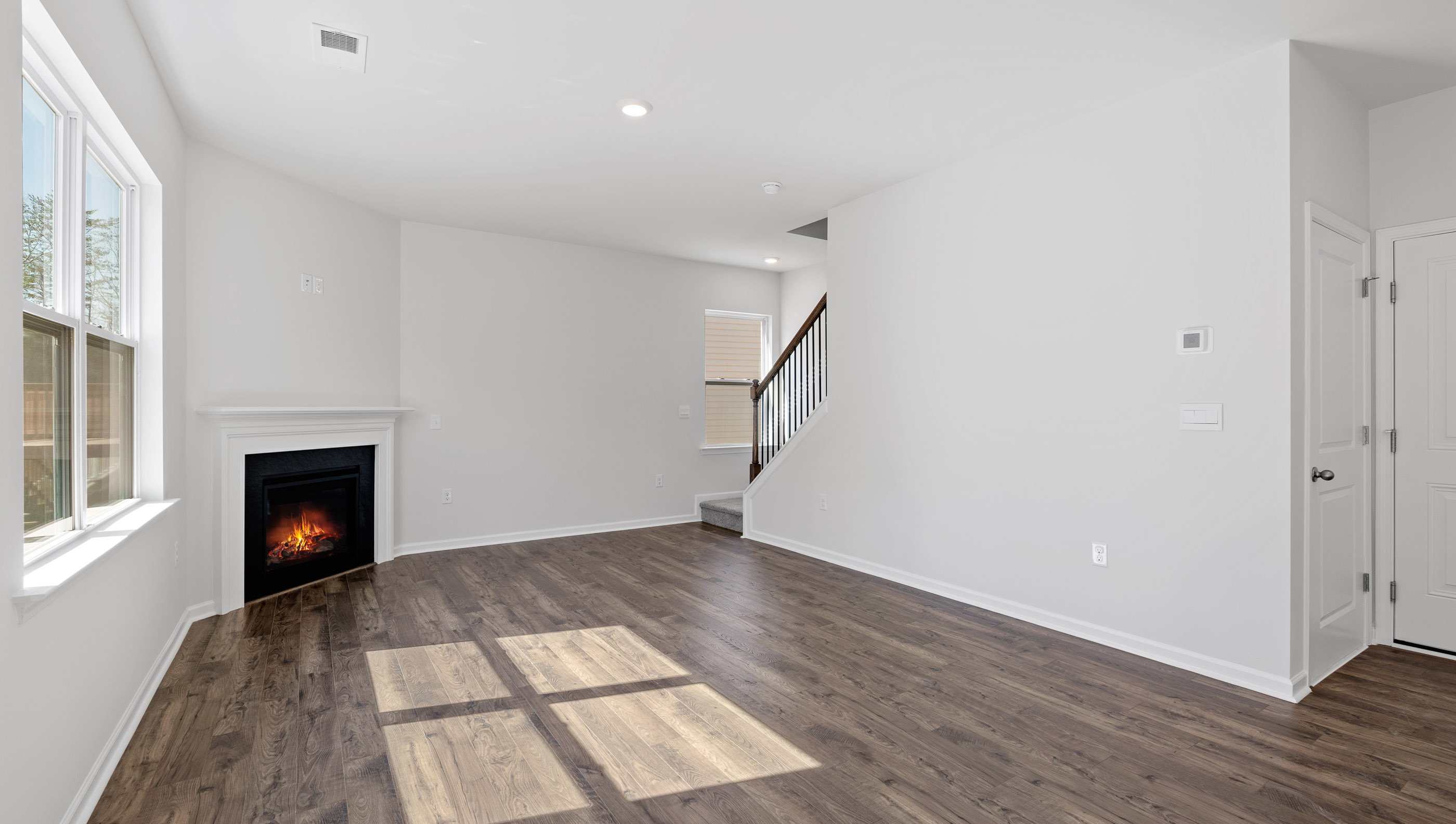 Living area with fireplace and windows.