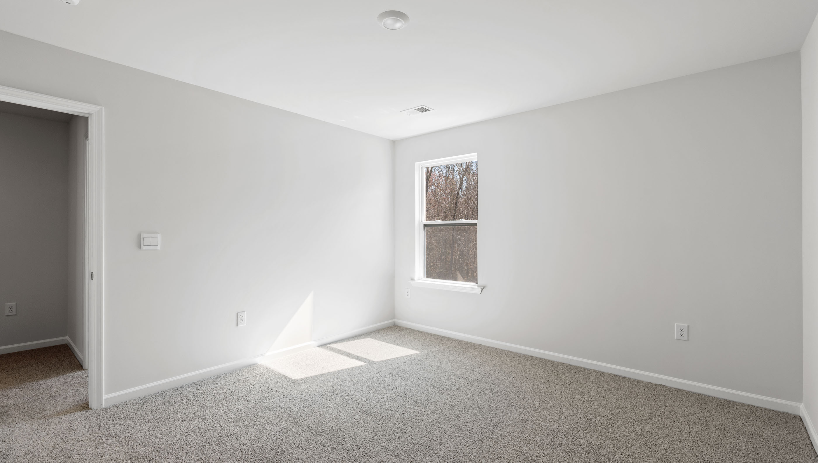 Bedroom with carpet and windows.