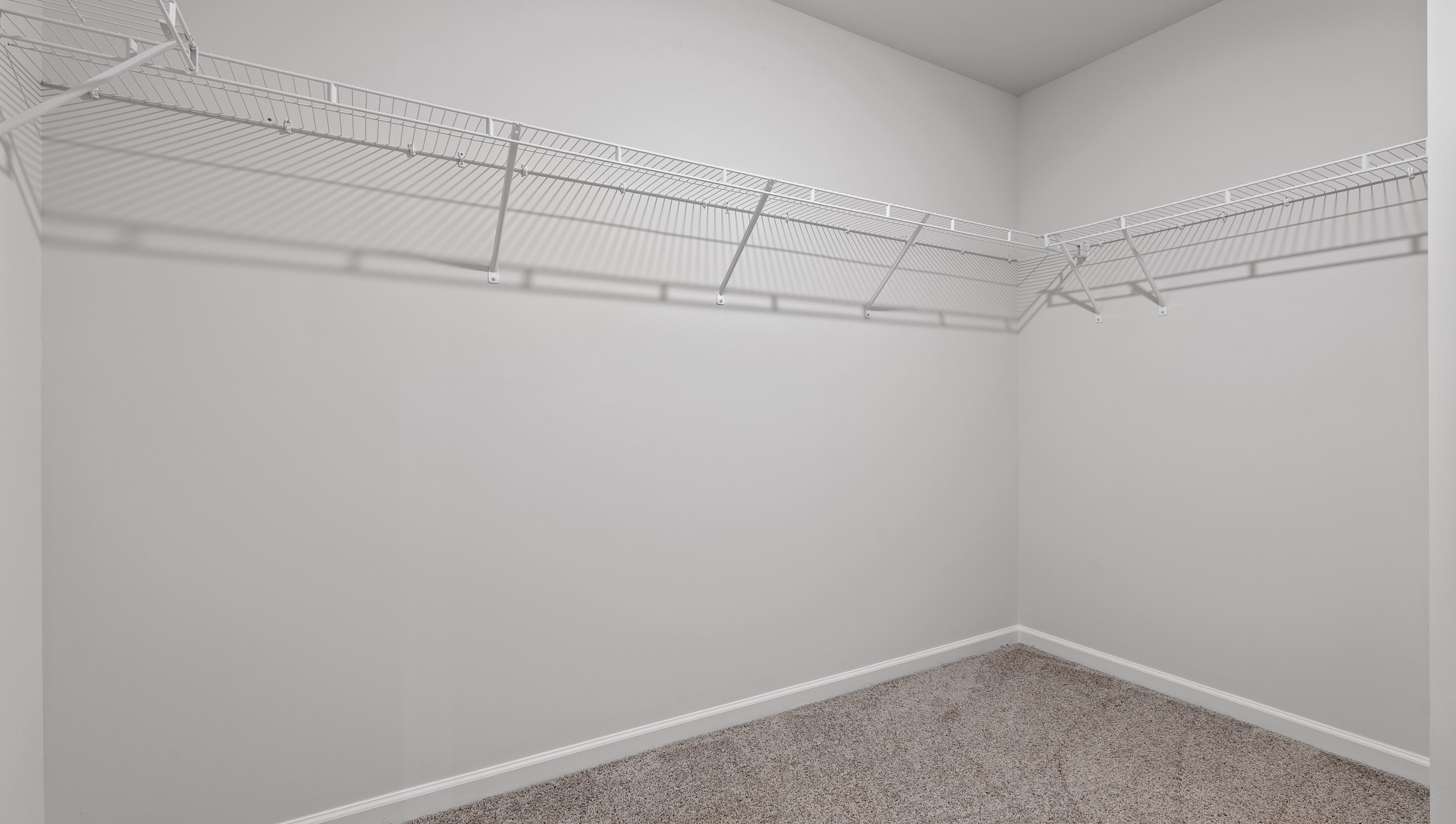 Primary closet with shelf.