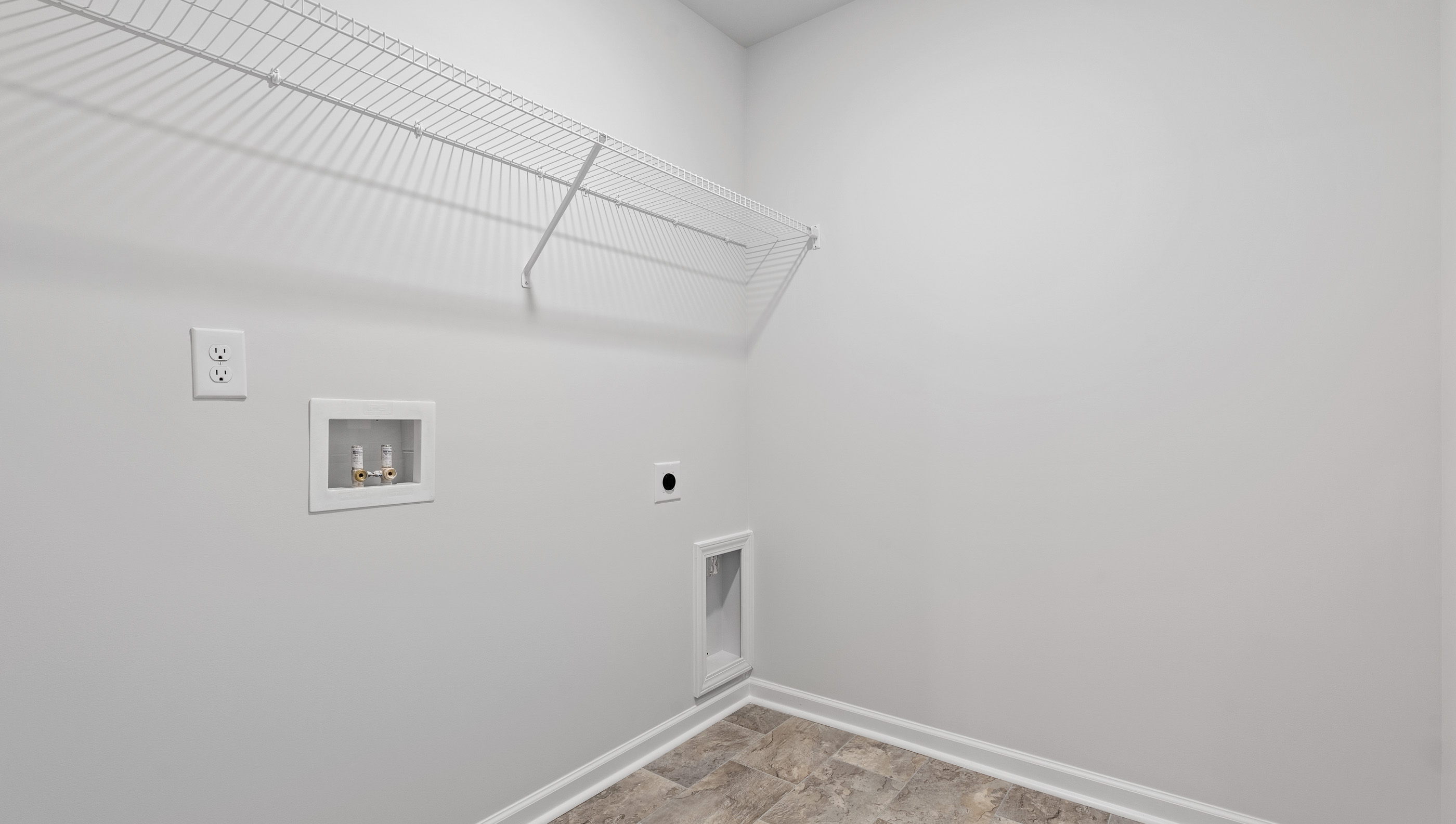 Laundry room with shelf.