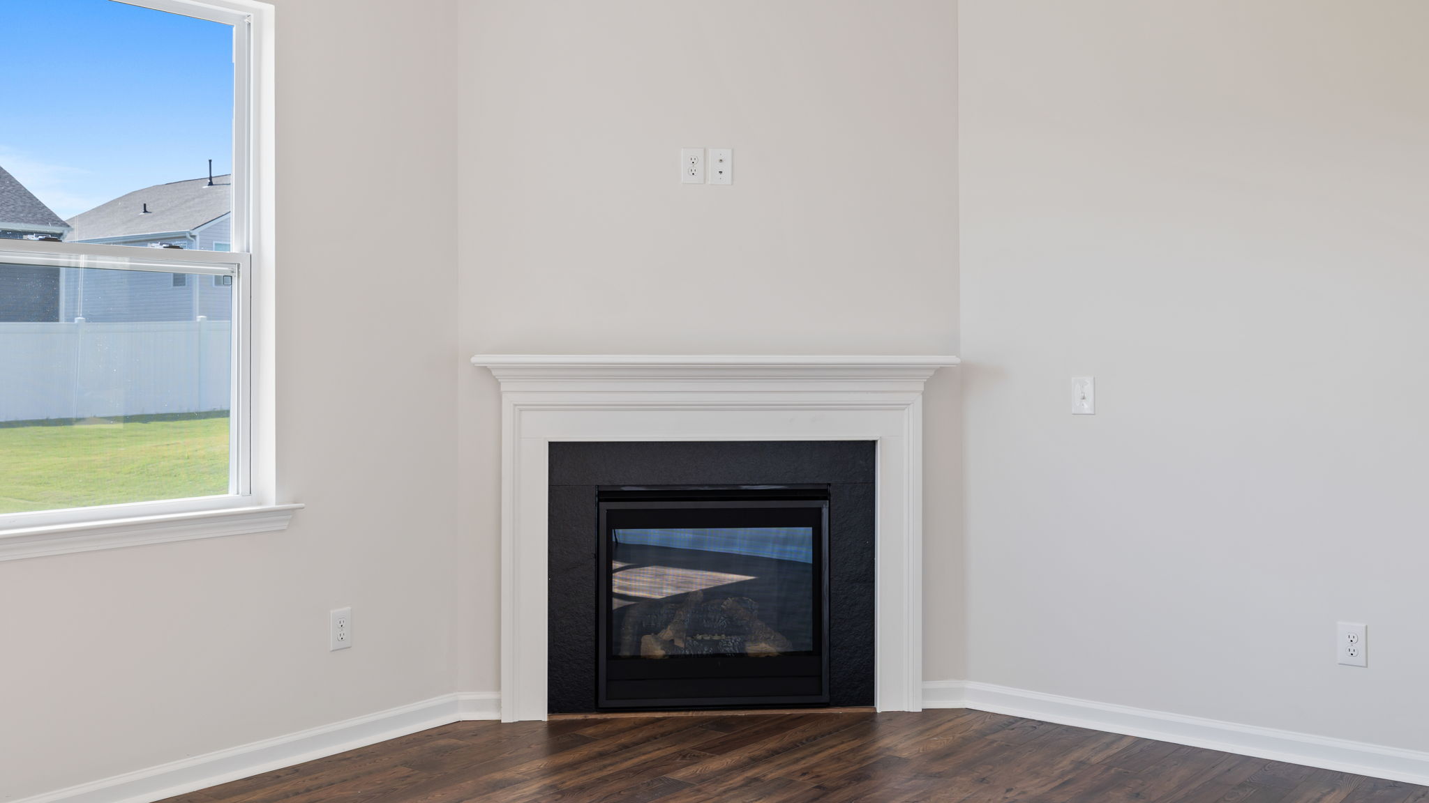 Family room with gas log fireplace and window.