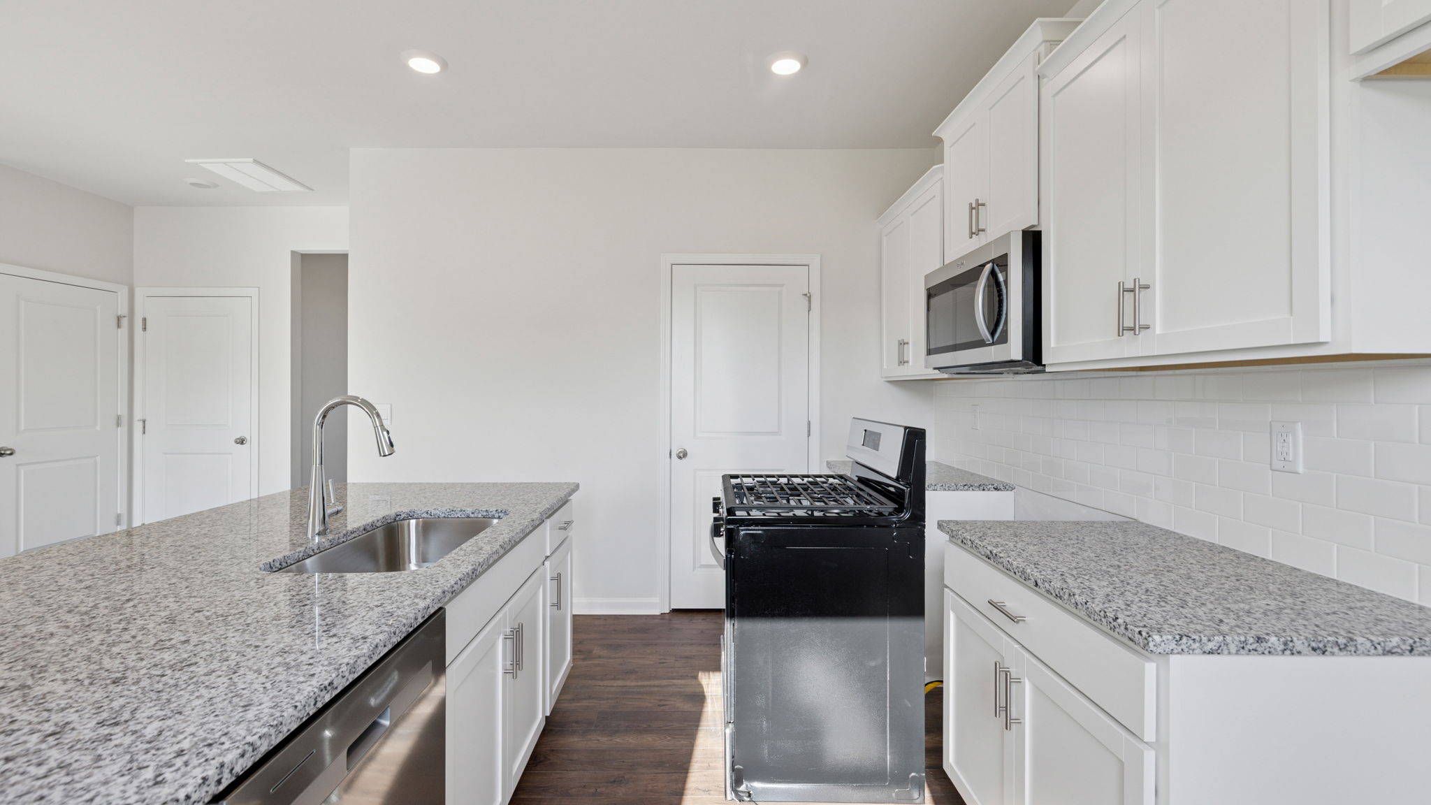 Kitchen with stainless steel appliances and walk in pantry.