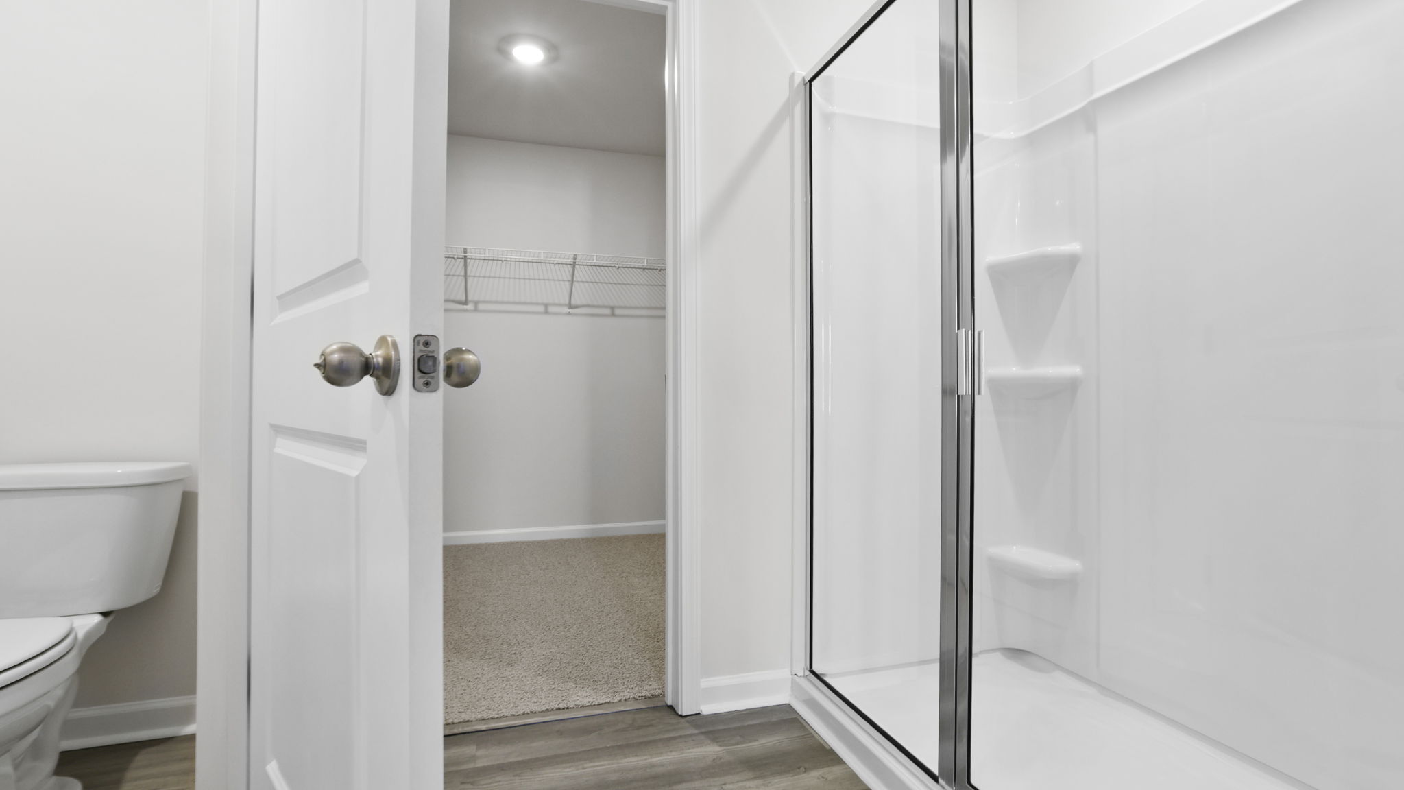 Primary bathroom with walk-in shower and garden tub.