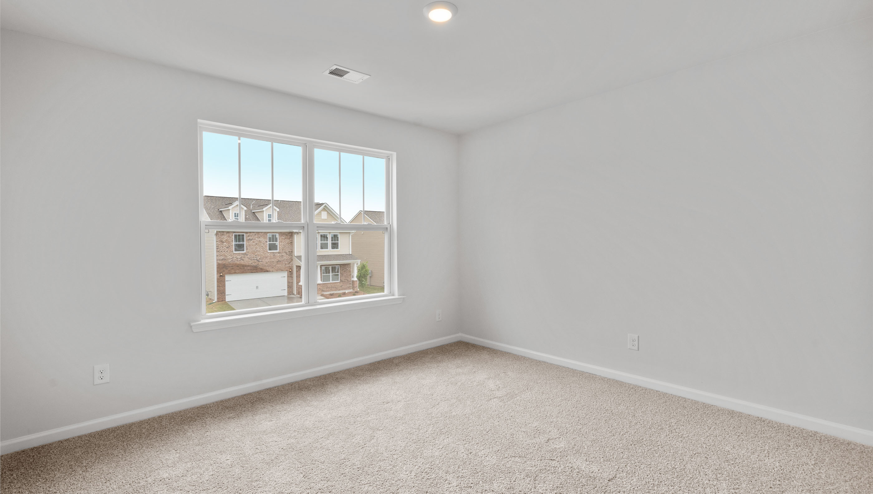 Bedroom with window and carpet.