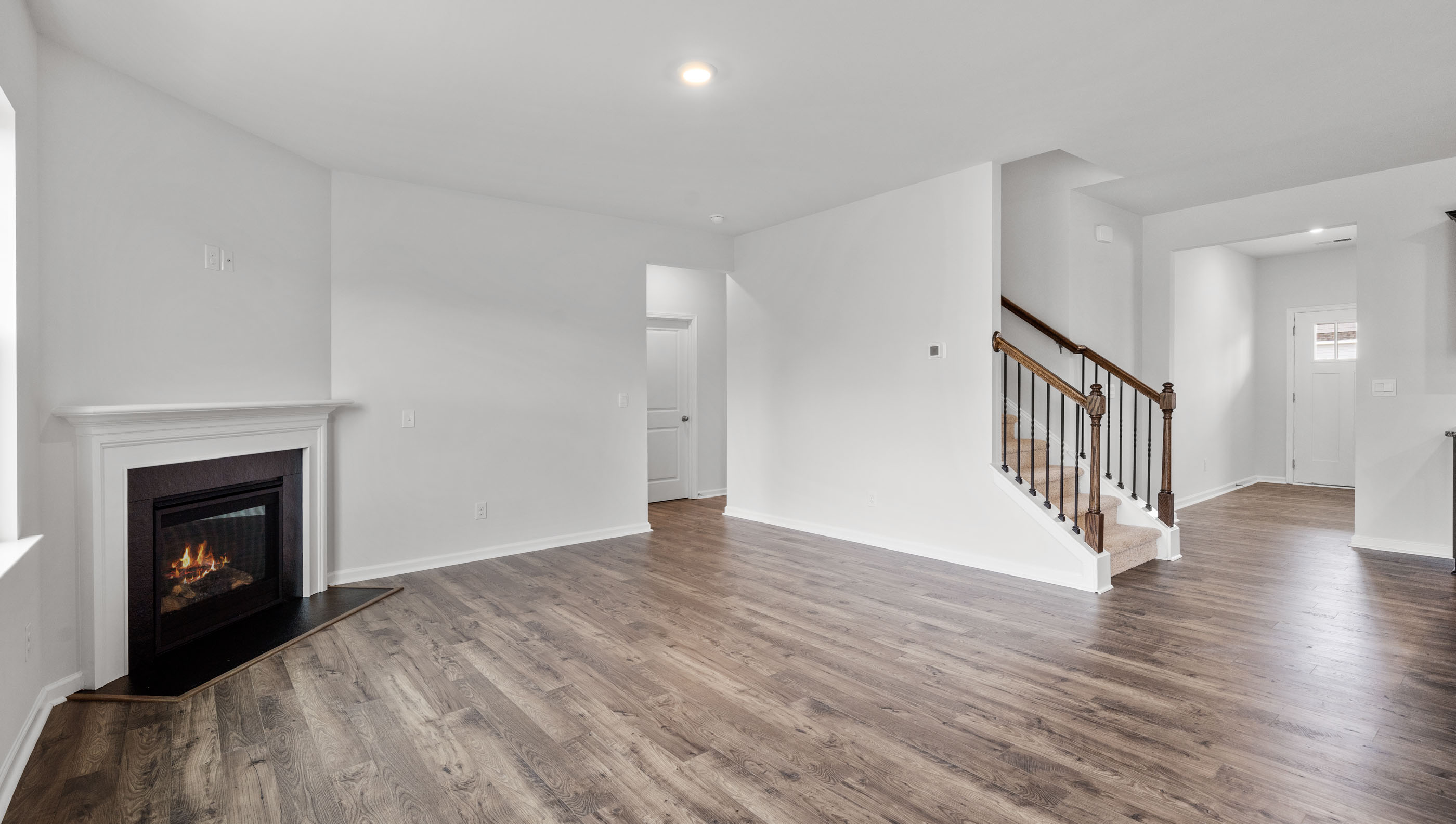 View of the family room with and stairwell to the upper level.