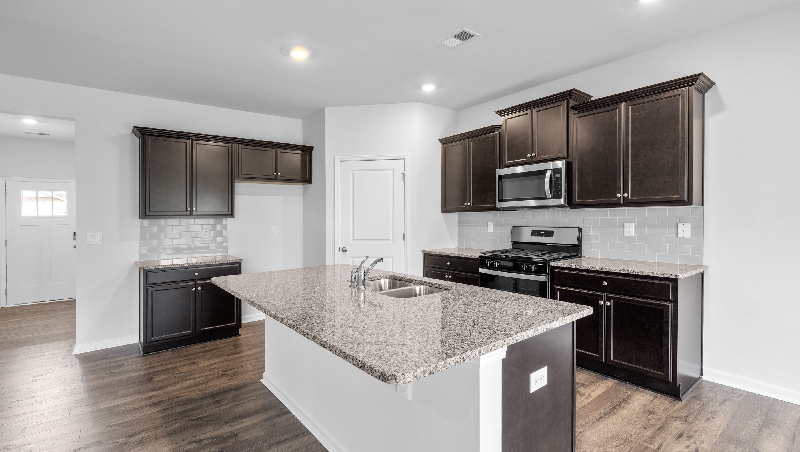 Kitchen and island with quartz countertops.