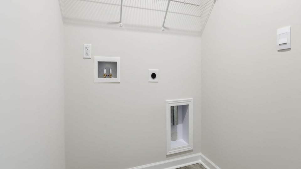 Laundry room with shelf.