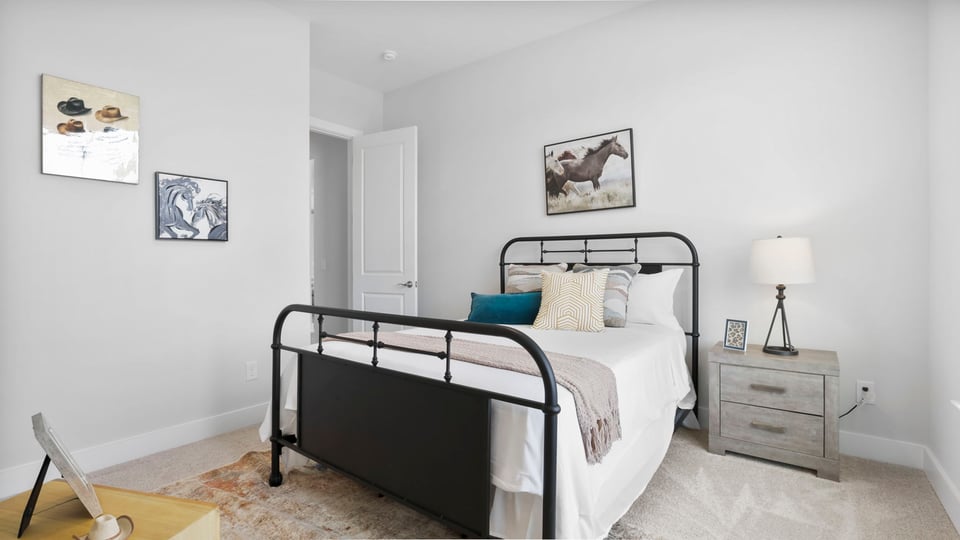 Bedroom with carpet and window.