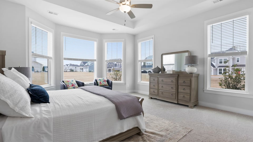 Bedroom with carpet and window.