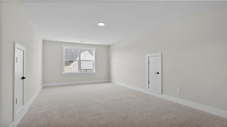 Bedroom with carpet and window.