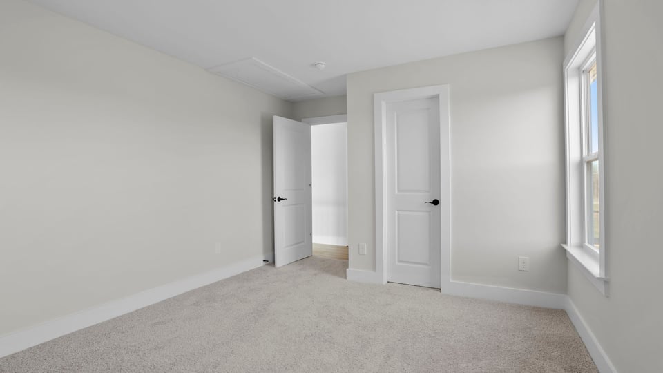 Bedroom with carpet and window.