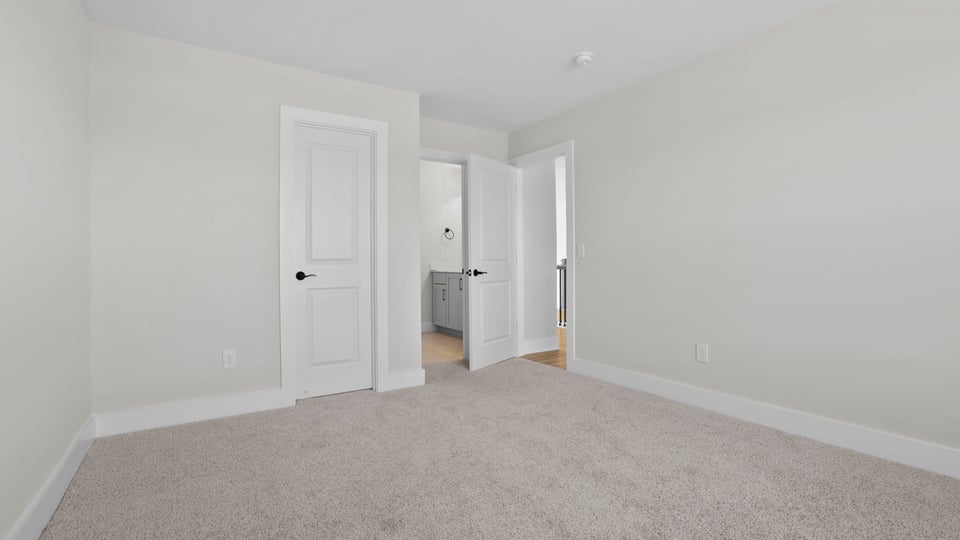 Bedroom with carpet and window.