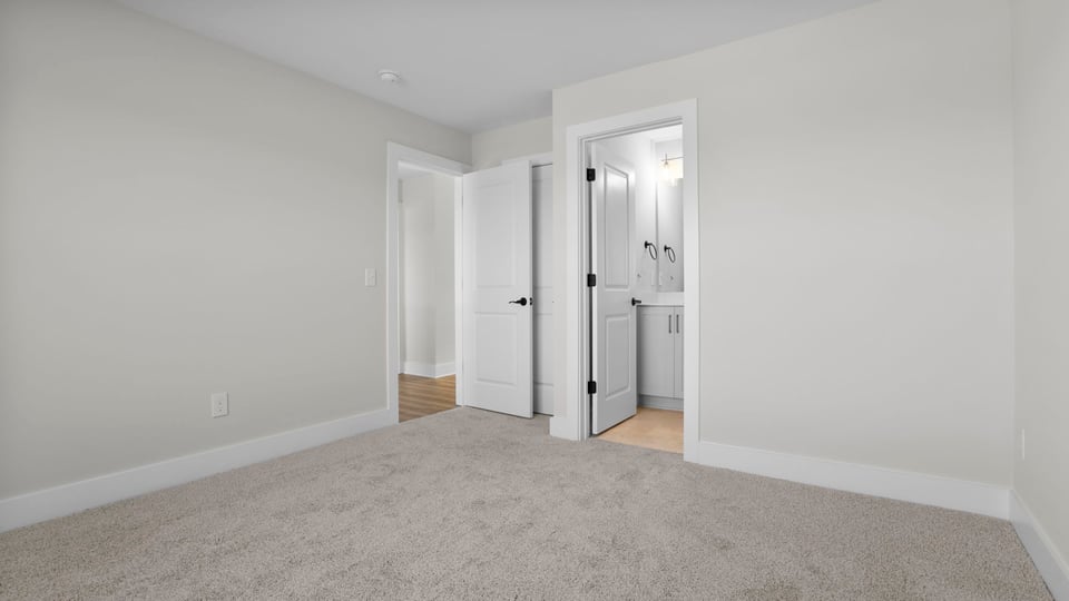 Bedroom with carpet and window.