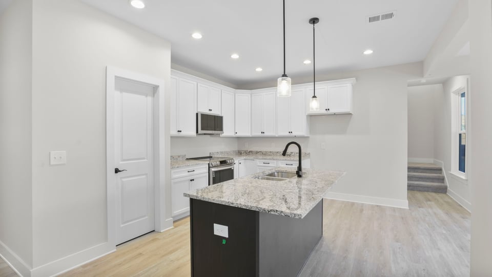 Kitchen and island with granite counter tops.