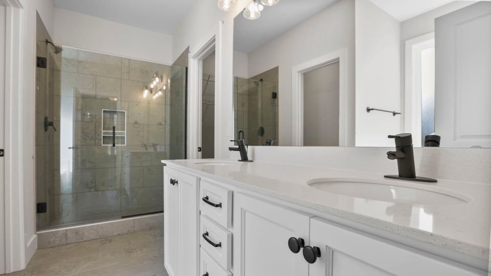 Bathroom with vanity and walk in shower.