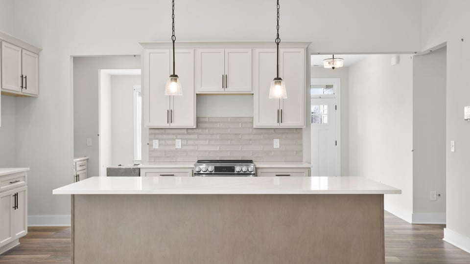 Kitchen and island with granite counter tops.