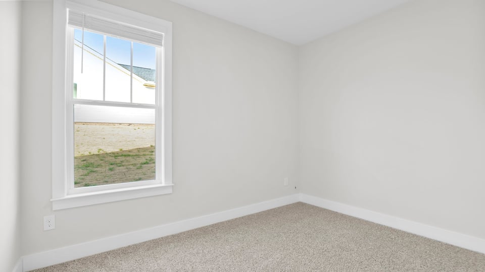 Bedroom with carpet and window.