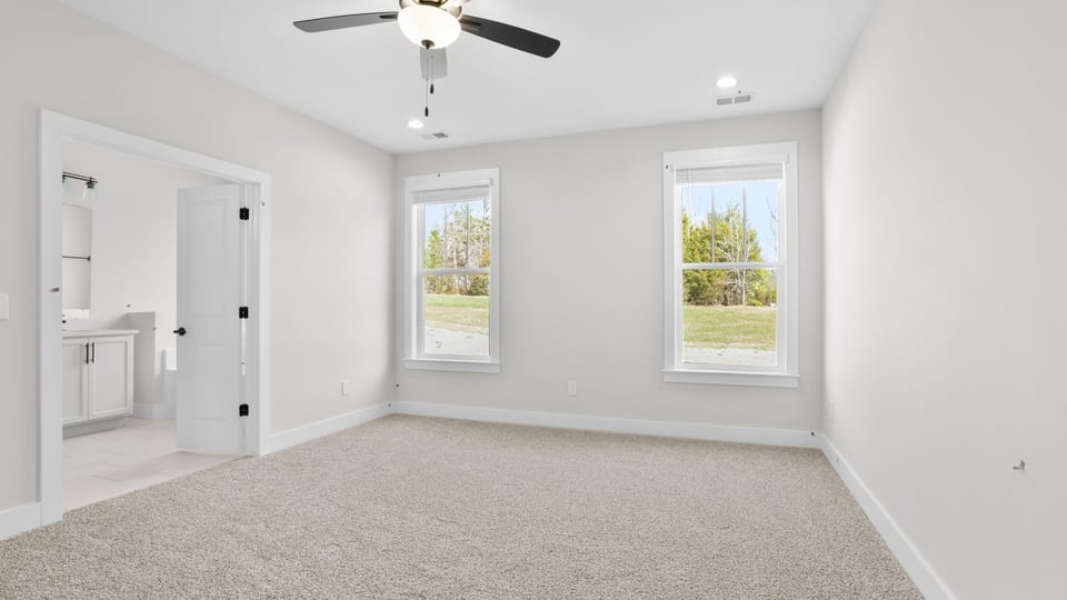 Bedroom with carpet and window.